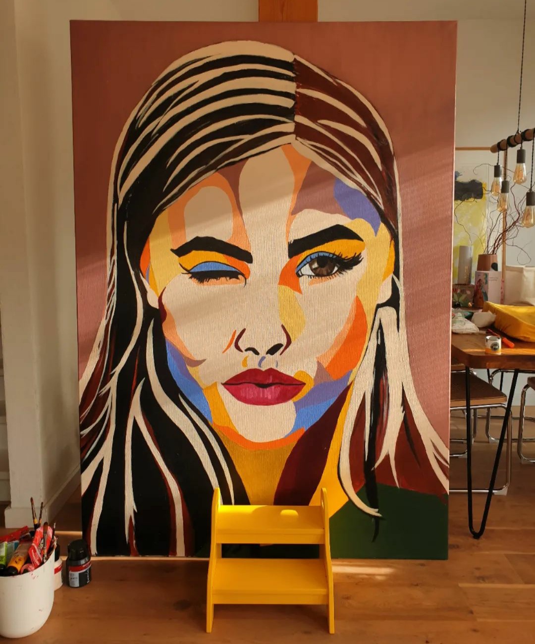 A colourful painted portrait in Fabienne's studio
