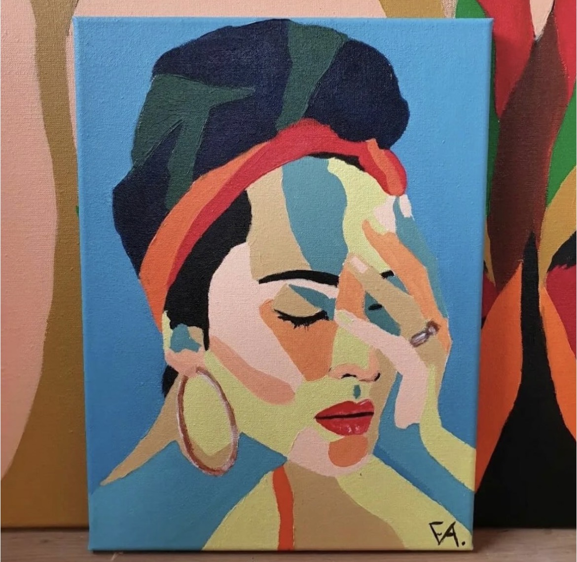 Painted portrait of a woman with a turban and gold hoop earring on a blue background, resting her hand against her face