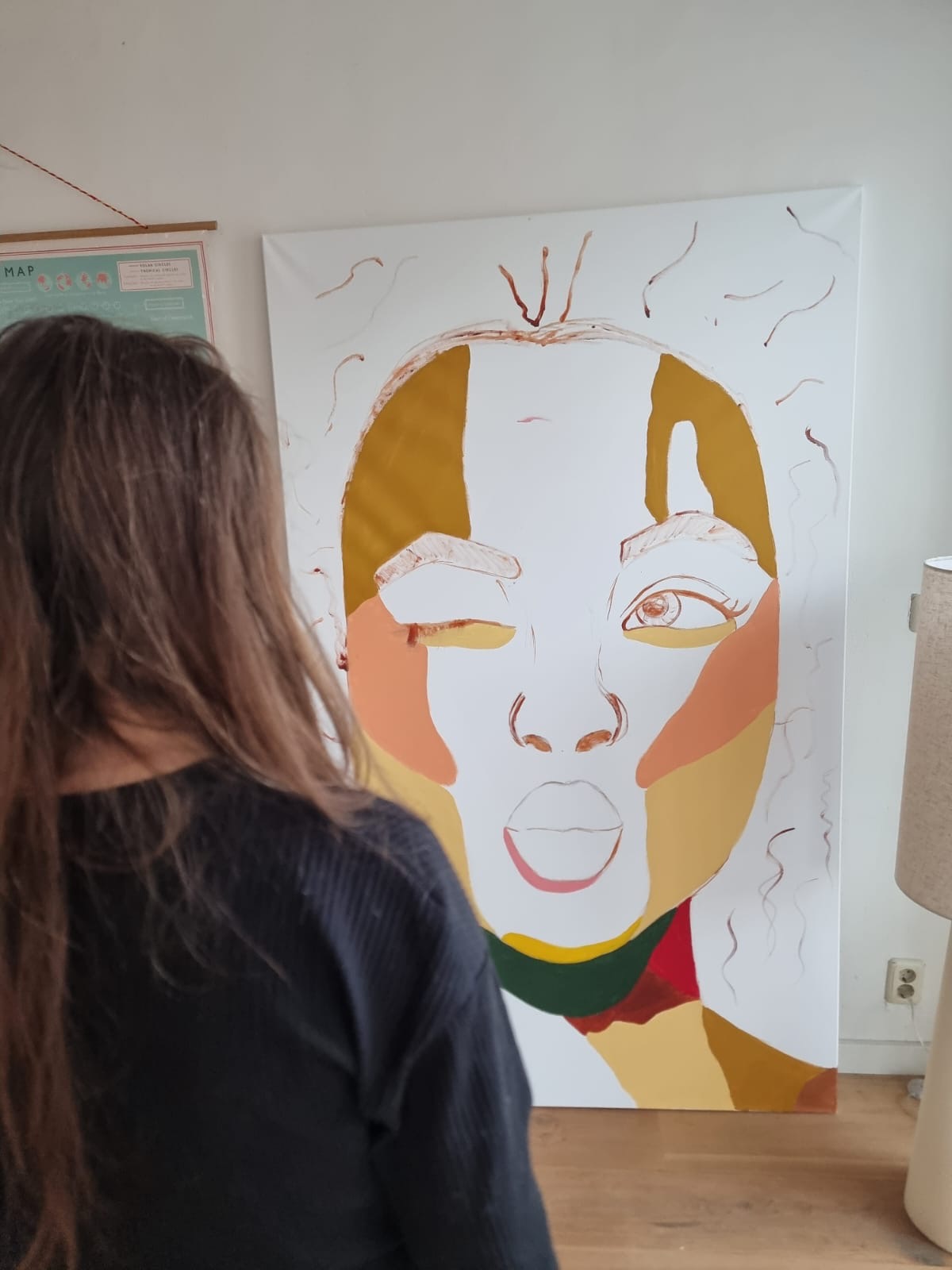 Fabienne working on a large colourful portrait in the studio
