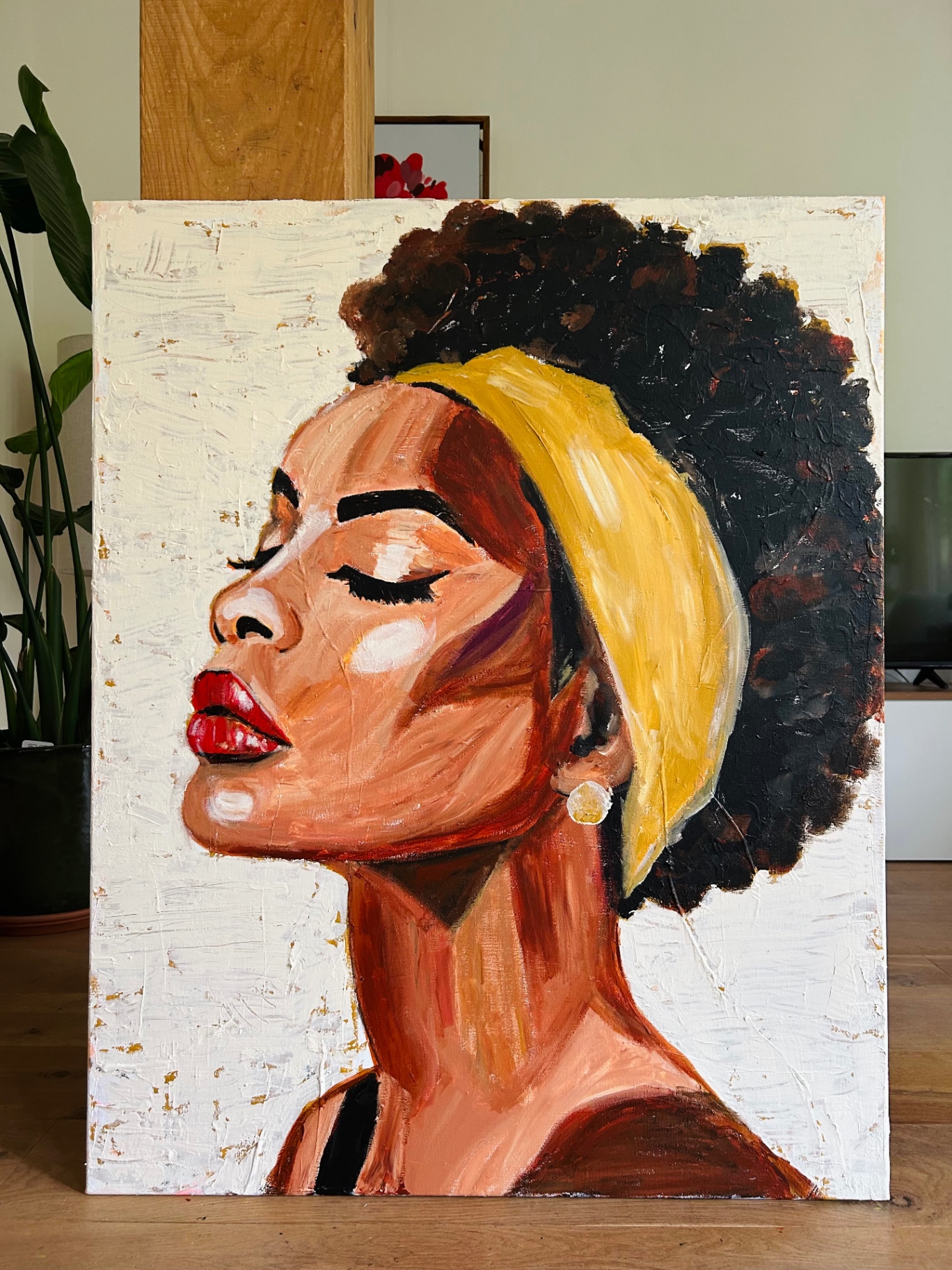 Profile portrait of a woman with eyes closed, dark curly hair and a yellow headband, painted in warm textured planes