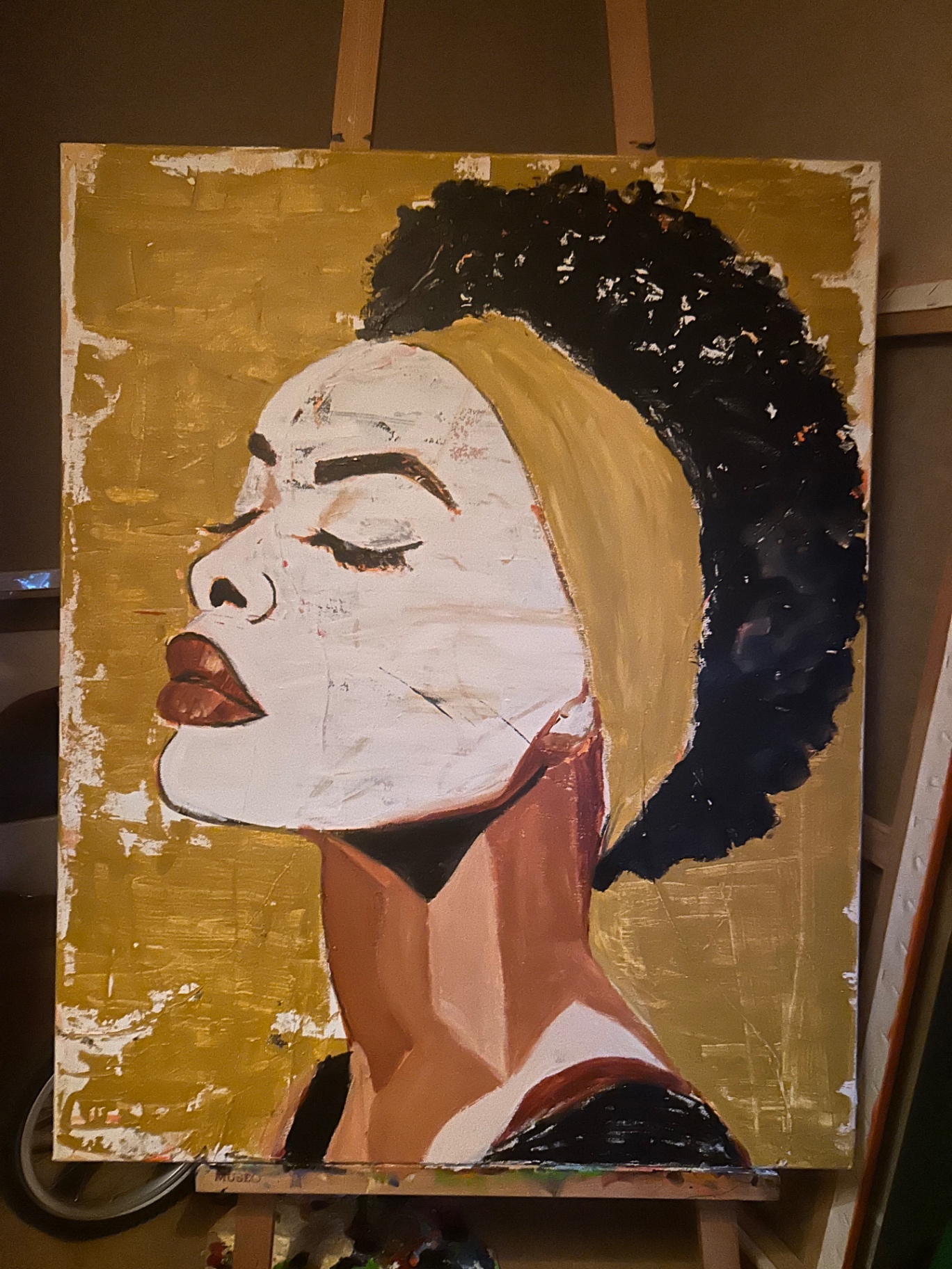 A portrait painting in progress on the studio easel